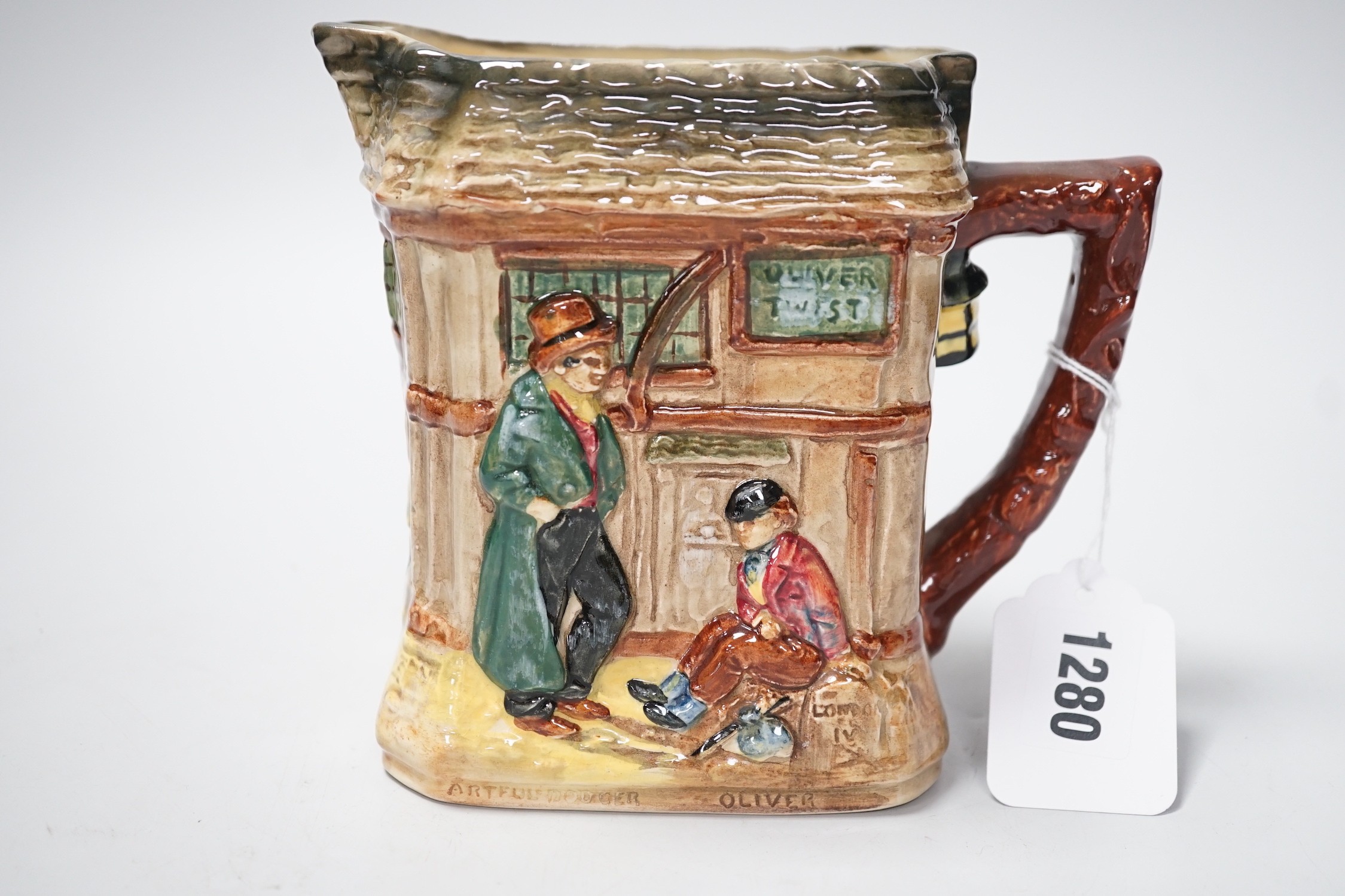 A Doulton Oliver Twist series ware jug and a Pelham puppet
